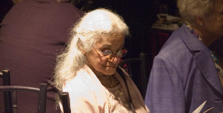 Older woman reading the program