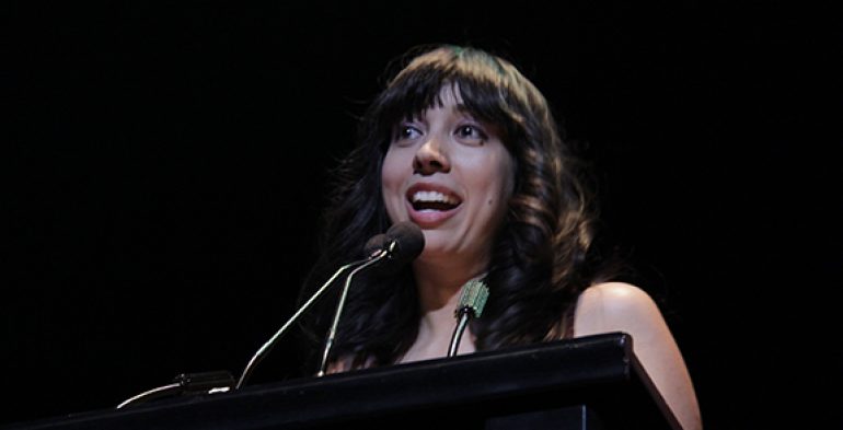 Young woman reading at a podium