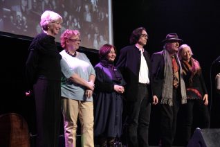 Four women and two men on stage